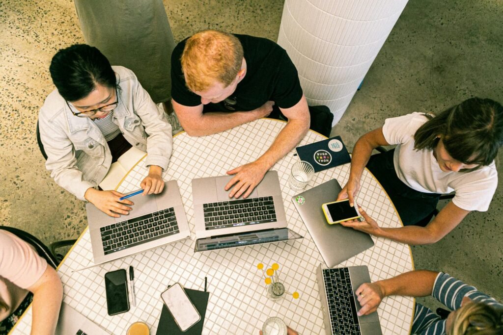 People Gathered Around a Table to Discuss Digital Marketing.